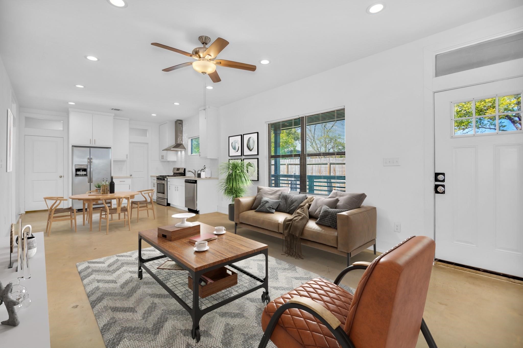 603 Edgewood Street, Unit B Houston, TX 77023 - Photo 3 of 16 Sun-drenched open living area features soaring ceilings, polished concrete floors, and expansive windows that flood the space with natural light.