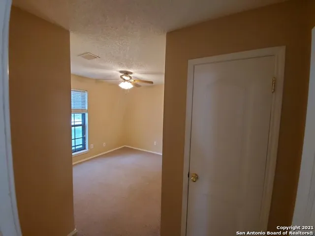 a view of a hallway with wooden floor and closet
