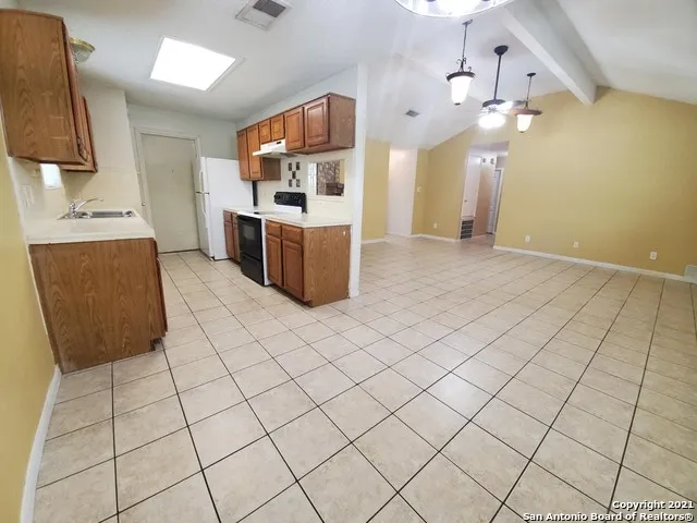 a kitchen with stainless steel appliances a sink and a counter top space
