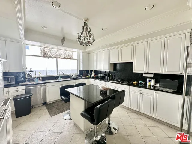 a kitchen with a sink cabinets and window