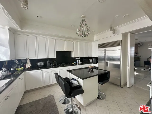 a kitchen with a sink stainless steel appliances and cabinets