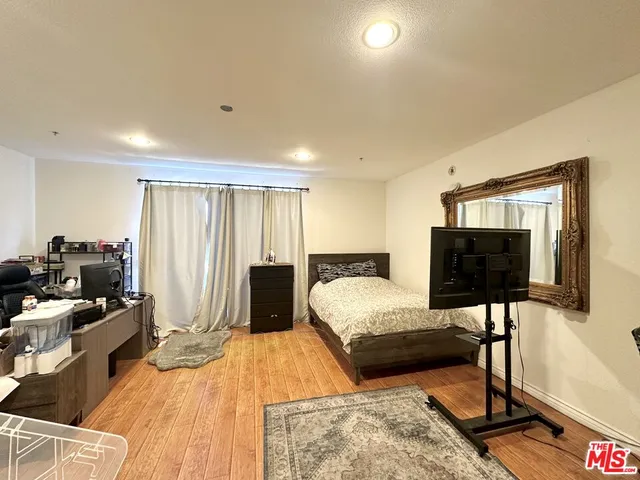 a bedroom with a bed and a flat screen tv