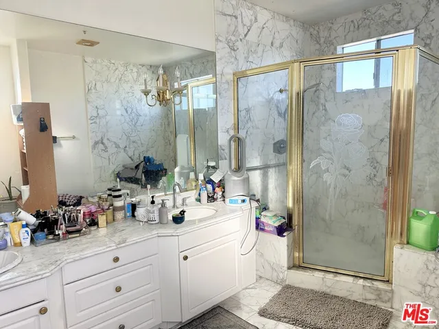 a bathroom with a double vanity sink mirror and shower