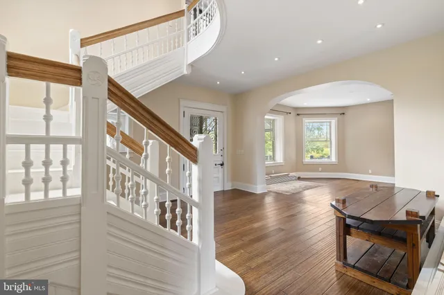 a view of a a dining room with furniture window and wooden floor