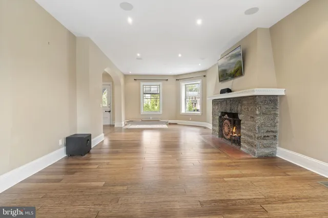a view of a dining room and livingroom with furniture wooden floor a chandelier