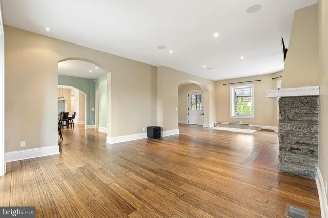 a large kitchen with kitchen island a large counter space a sink appliances and cabinets
