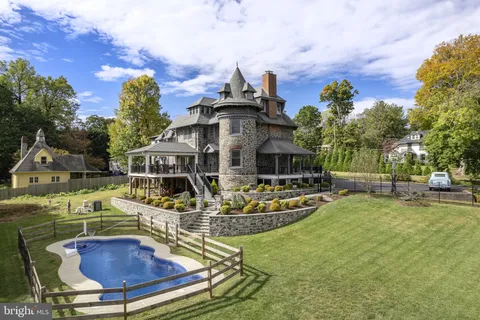 a front view of house with a garden and swimming pool