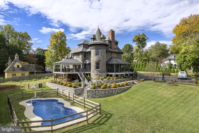 a front view of house with a garden and swimming pool