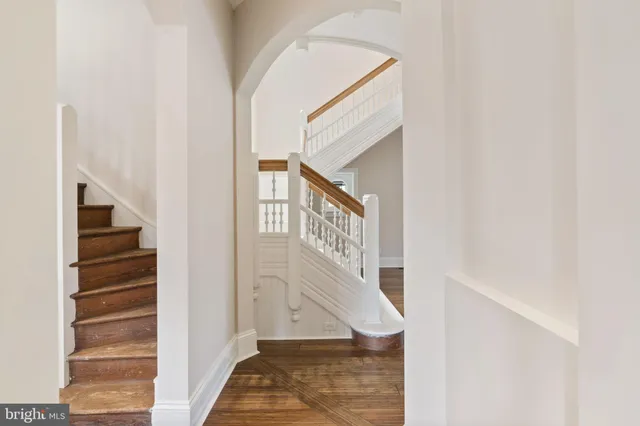 an empty room with windows and fireplace