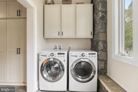an empty room with a window and a ceiling fan