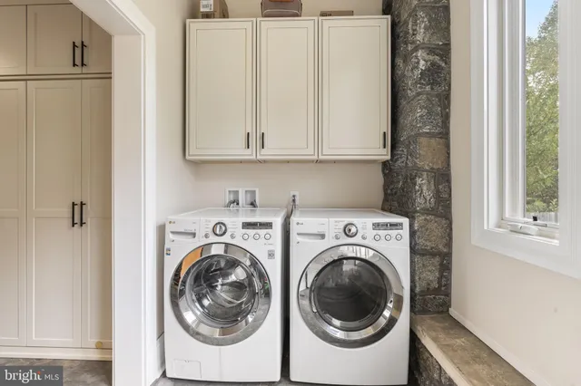an empty room with a window and a ceiling fan