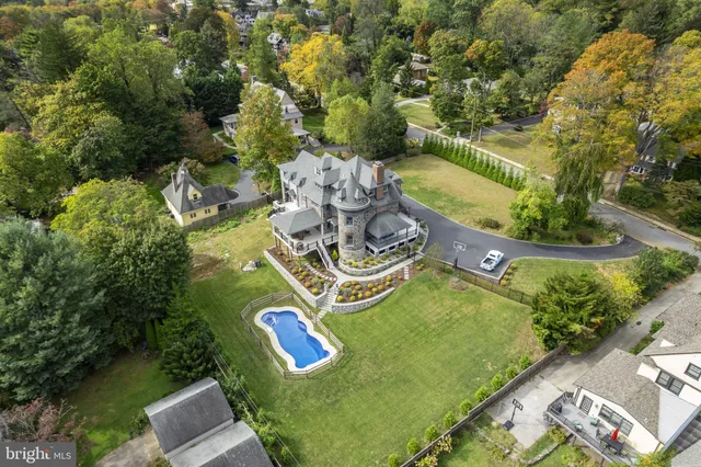an aerial view of a house with garden space and street view
