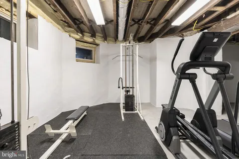 a view of an empty room with a window and a kitchen