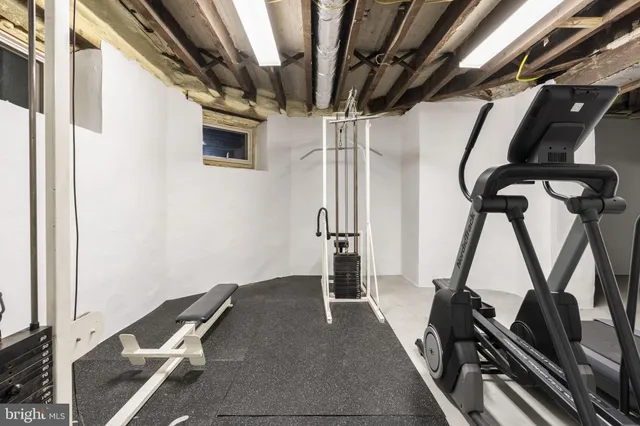 a view of an empty room with a window and a kitchen