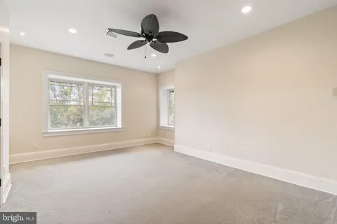 an aerial view of a house with swimming pool and patio