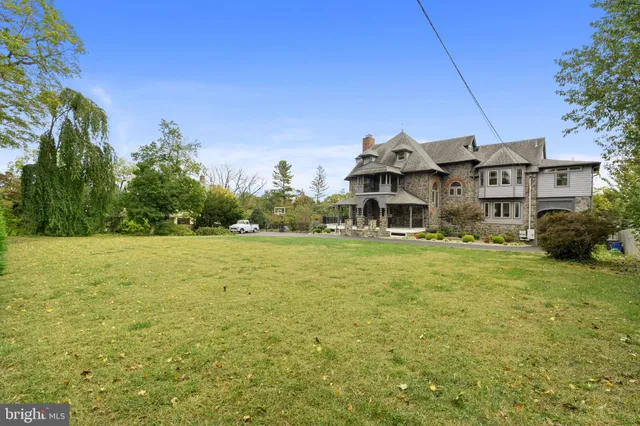a front view of a house with a big yard