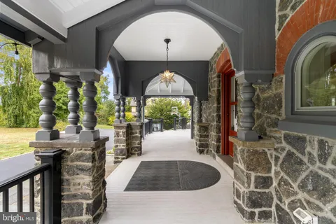 a view of a livingroom with furniture a fireplace and wooden floor