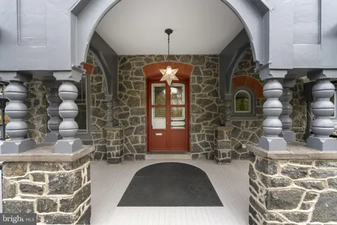 a view of empty room with fireplace and wooden floor