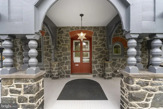 a view of empty room with fireplace and wooden floor