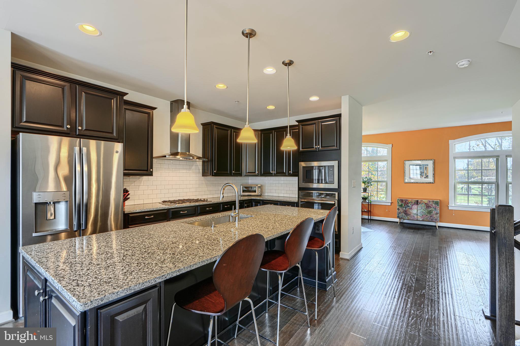 30 Wedge Way, Unit 12 Baltimore, MD 21208 - Photo 13 of 42 a kitchen with stainless steel appliances granite countertop a kitchen island a stove a table and chairs