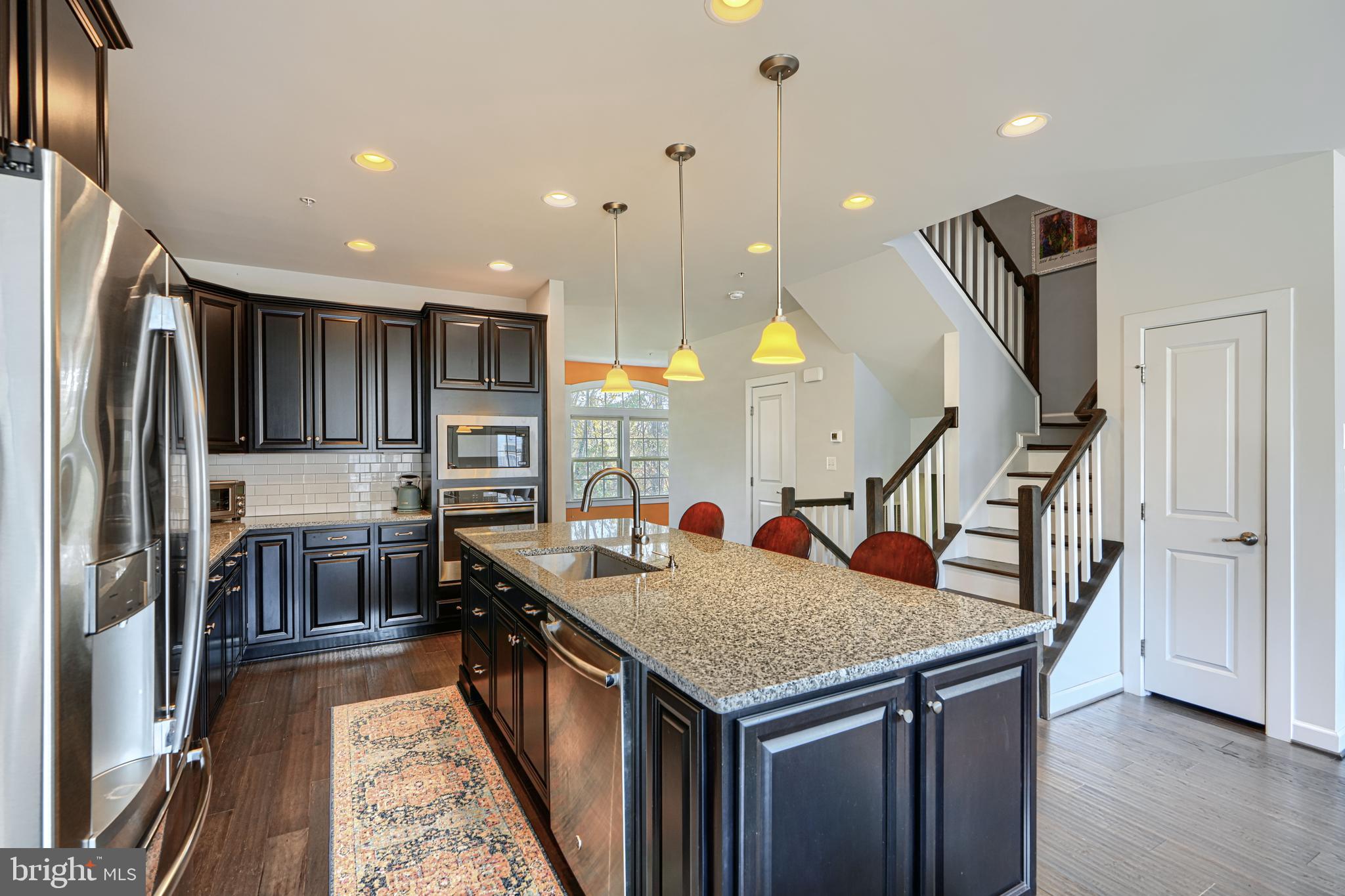 30 Wedge Way, Unit 12 Baltimore, MD 21208 - Photo 14 of 42 a kitchen with stainless steel appliances granite countertop a sink a stove and a refrigerator