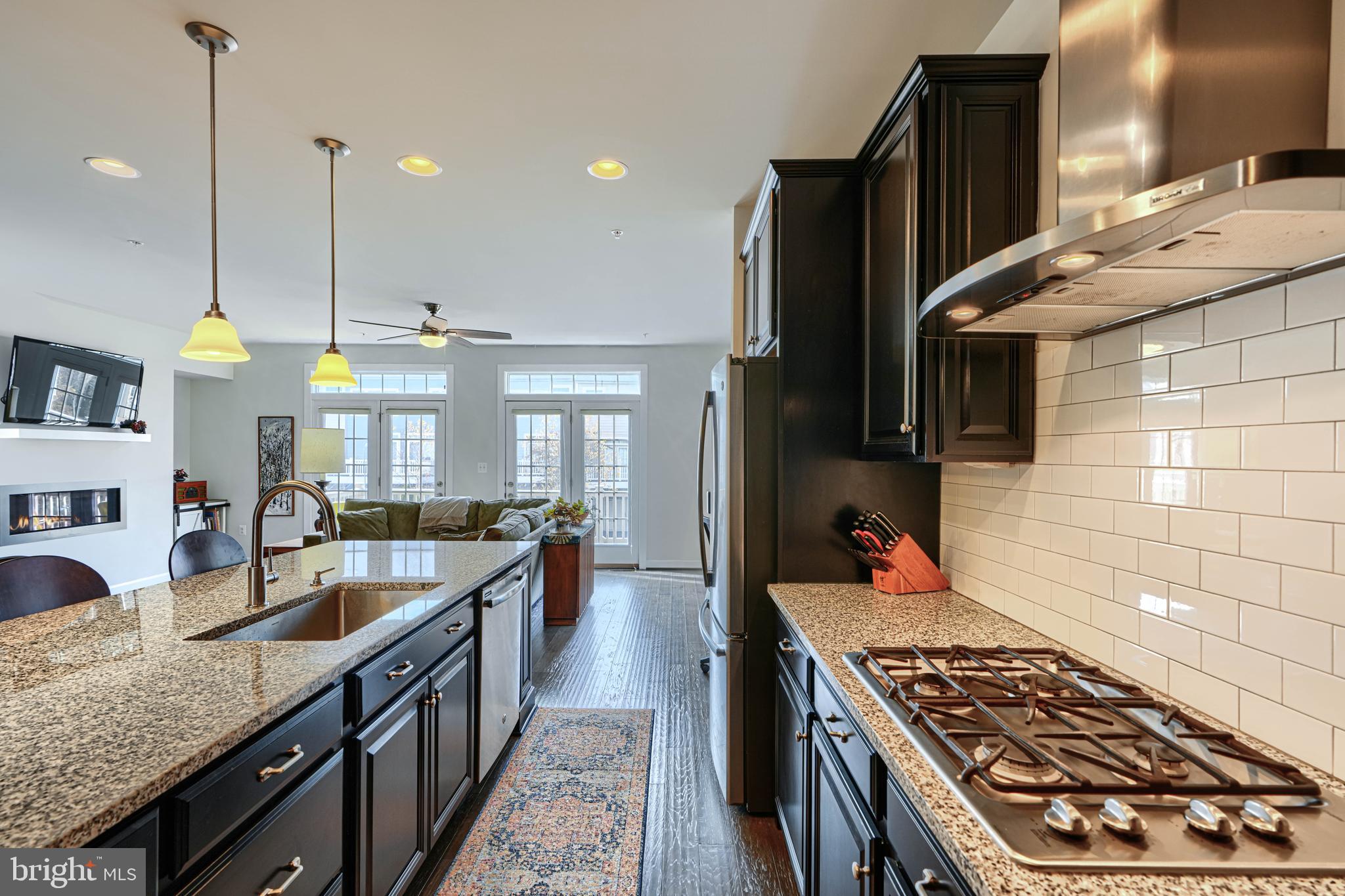 30 Wedge Way, Unit 12 Baltimore, MD 21208 - Photo 15 of 42 a kitchen with stainless steel appliances granite countertop a stove a sink and a refrigerator