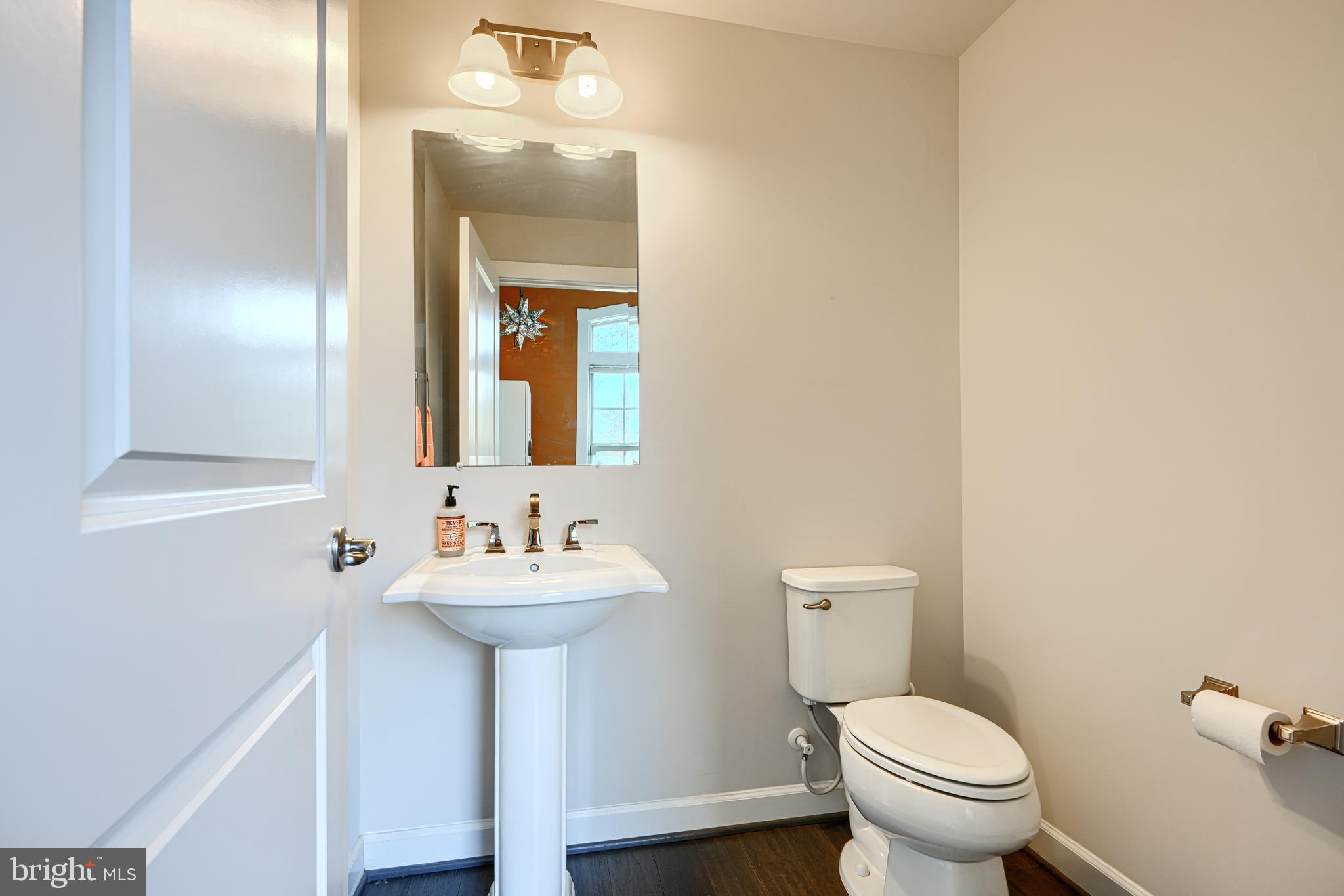 30 Wedge Way, Unit 12 Baltimore, MD 21208 - Photo 23 of 42 a bathroom with a sink mirror and toilet