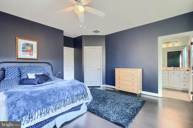 a bedroom with a large bed and a chandelier