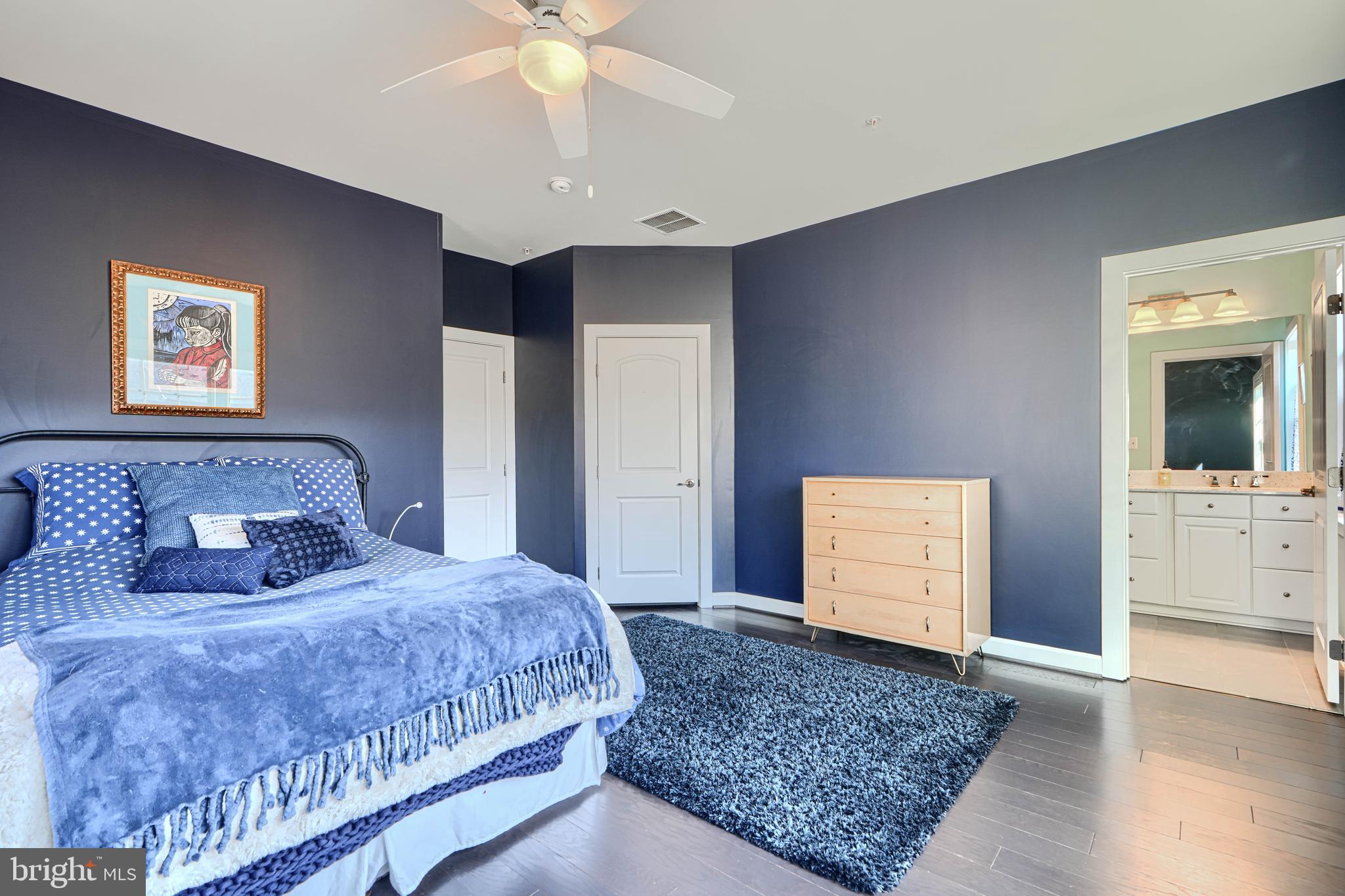 30 Wedge Way, Unit 12 Baltimore, MD 21208 - Photo 26 of 42 a bedroom with a large bed and a chandelier