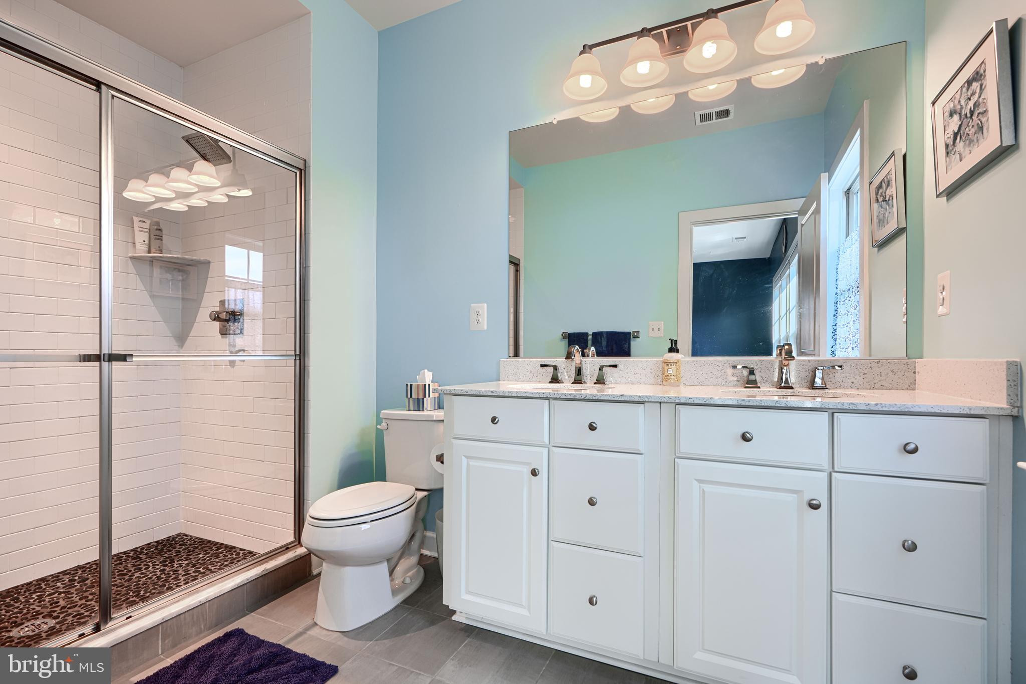 30 Wedge Way, Unit 12 Baltimore, MD 21208 - Photo 27 of 42 a bathroom with a sink a toilet and a mirror