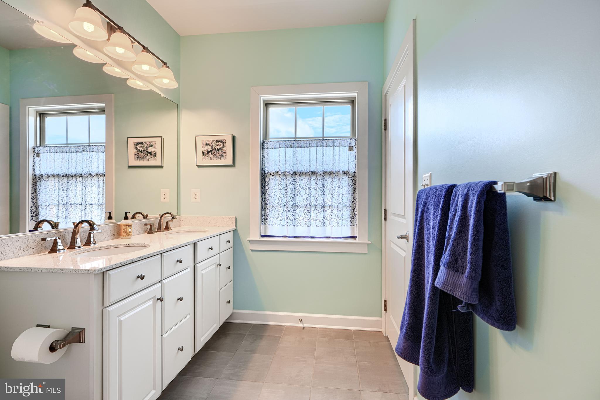 30 Wedge Way, Unit 12 Baltimore, MD 21208 - Photo 29 of 42 a bathroom with a sink and a mirror