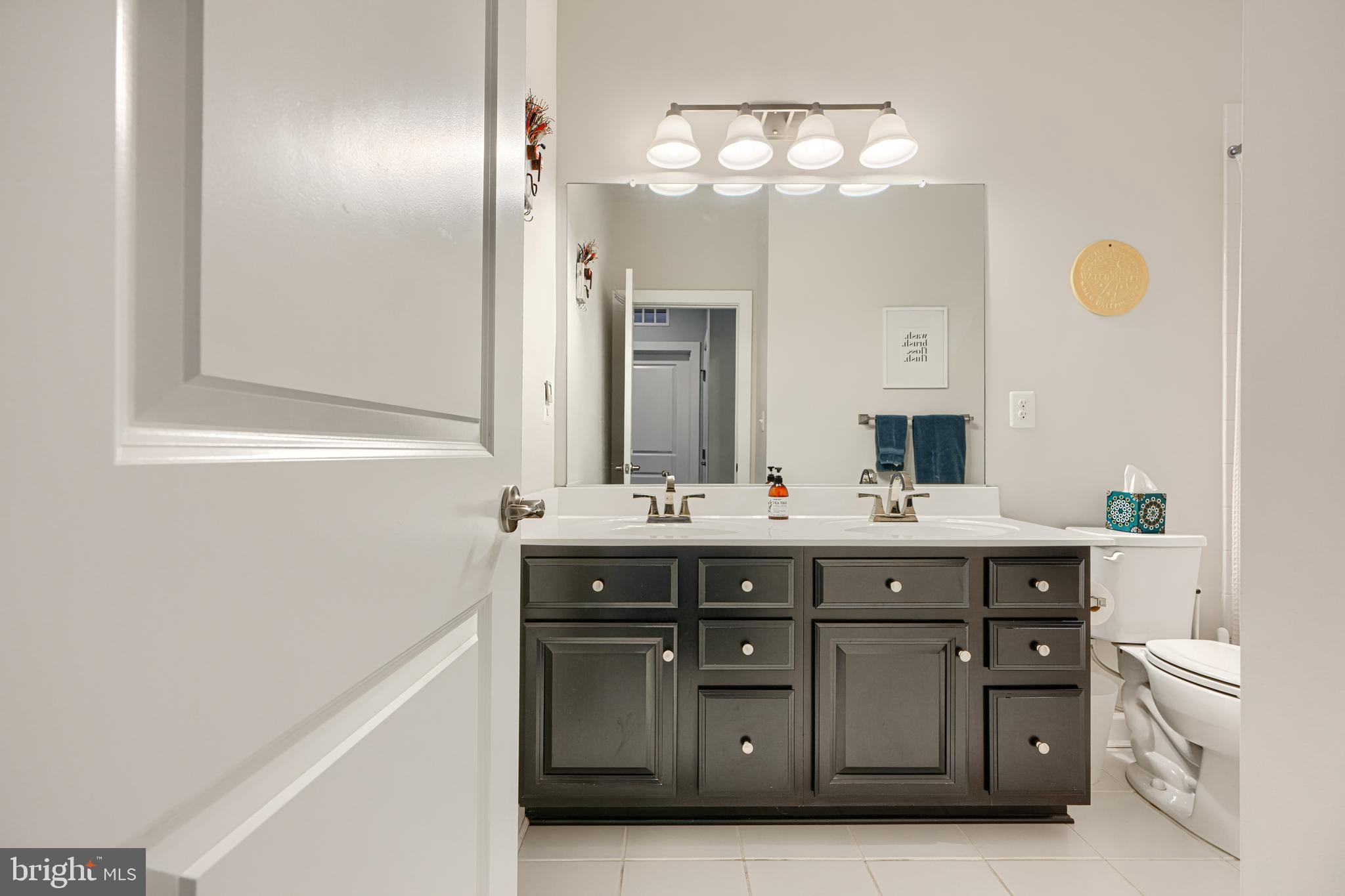 30 Wedge Way, Unit 12 Baltimore, MD 21208 - Photo 35 of 42 a spacious bathroom with a double vanity sink double and mirror
