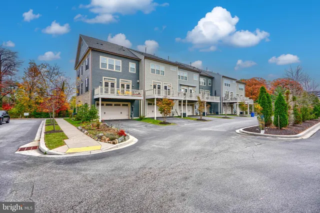 a view of an house with backyard and fire pit