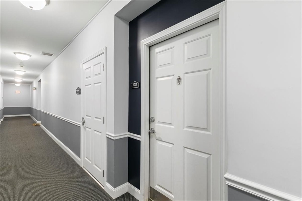 23 Hampshire Road, Unit 108 Methuen, MA 01844 - Photo 3 of 39 a view of a hallway with the wooden floor