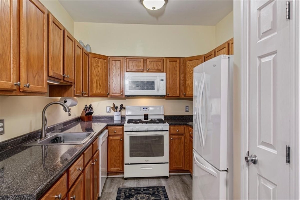 23 Hampshire Road, Unit 108 Methuen, MA 01844 - Photo 6 of 39 a kitchen with stainless steel appliances granite countertop a stove a sink dishwasher and a refrigerator
