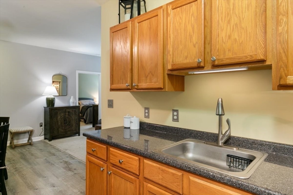 23 Hampshire Road, Unit 108 Methuen, MA 01844 - Photo 8 of 39 a kitchen with granite countertop a sink a stove and cabinets