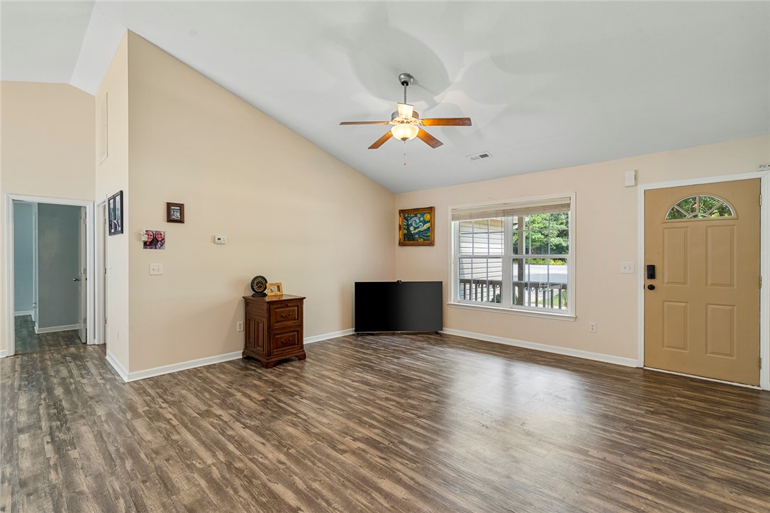 167 Mediterranean Avenue Anderson, SC 29621 - Photo 8 of 33 A well-lit living area features vaulted ceilings and resilient flooring.