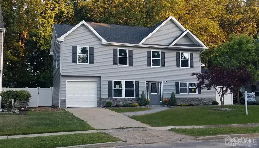 107 Winthrop Road Edison, NJ 08817 - Photo 1 of 38 a front view of a house with a yard