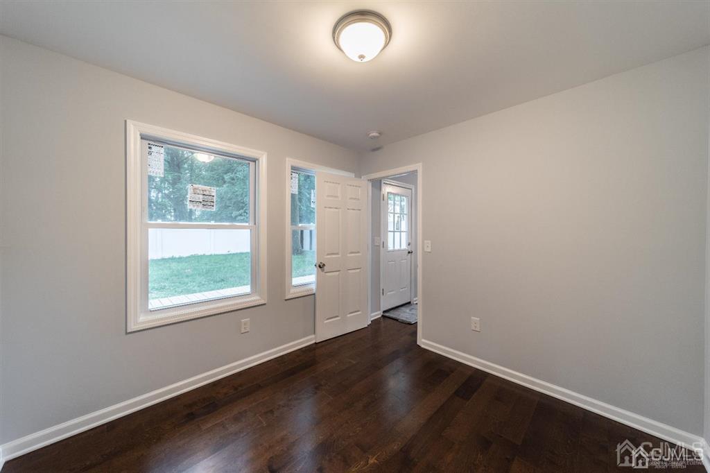 107 Winthrop Road Edison, NJ 08817 - Photo 19 of 38 an empty room with wooden floor and windows