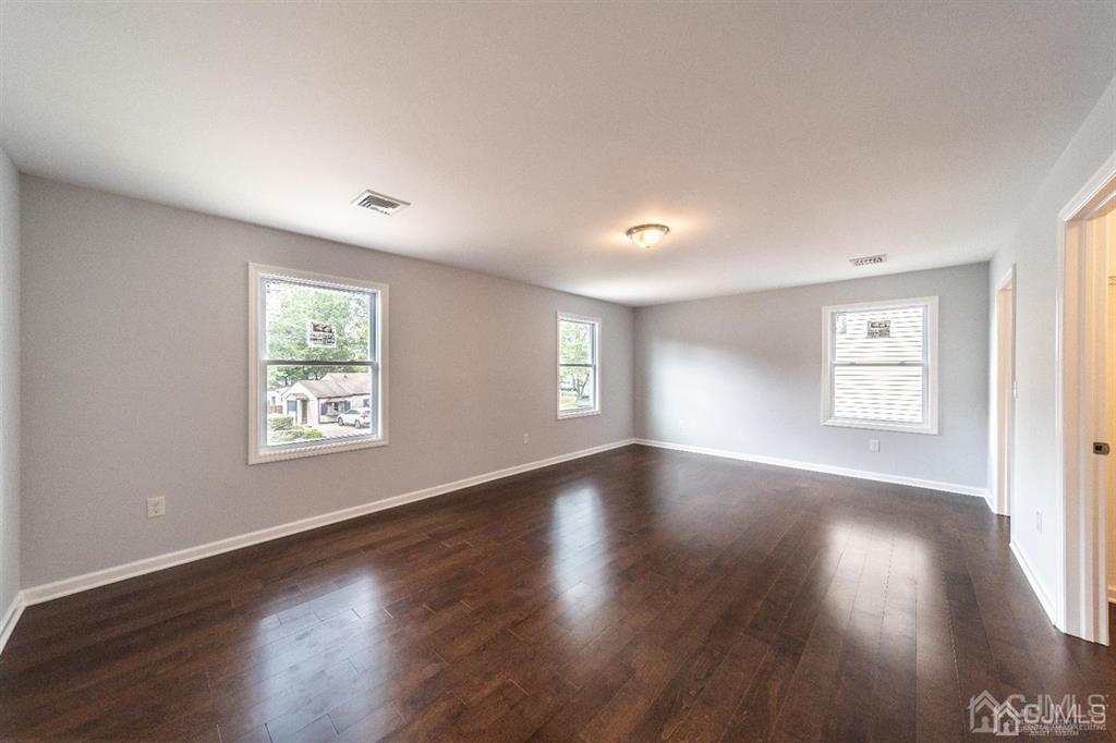 107 Winthrop Road Edison, NJ 08817 - Photo 23 of 38 a view of an empty room with wooden floor and window