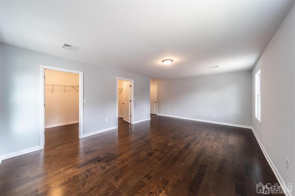 107 Winthrop Road Edison, NJ 08817 - Photo 24 of 38 an empty room with wooden floor and natural light