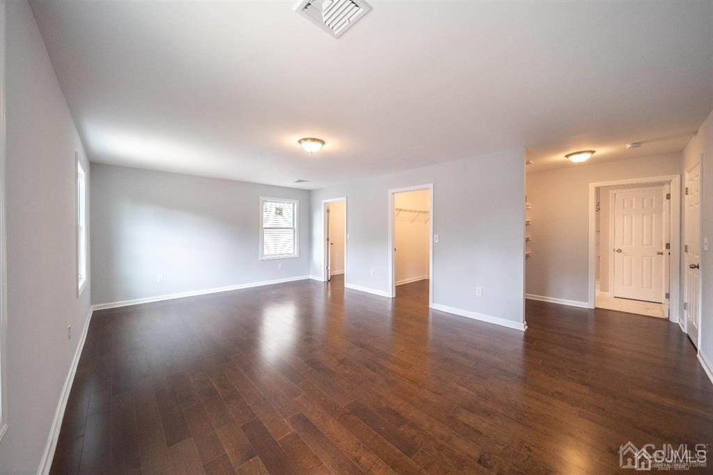 107 Winthrop Road Edison, NJ 08817 - Photo 25 of 38 a view of an empty room with wooden floor and a window