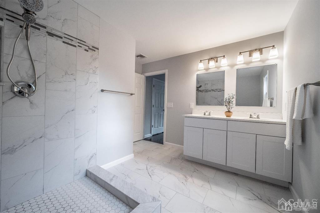 107 Winthrop Road Edison, NJ 08817 - Photo 28 of 38 a spacious bathroom with a double vanity sink mirror and shower