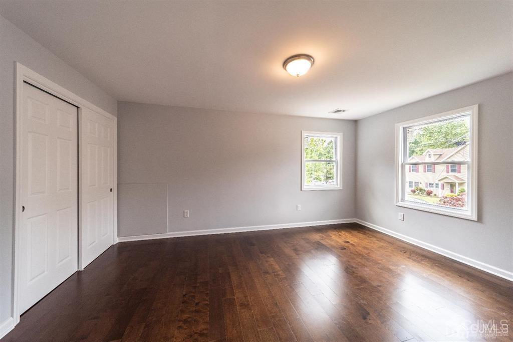 107 Winthrop Road Edison, NJ 08817 - Photo 31 of 38 a view of an empty room with wooden floor and a window