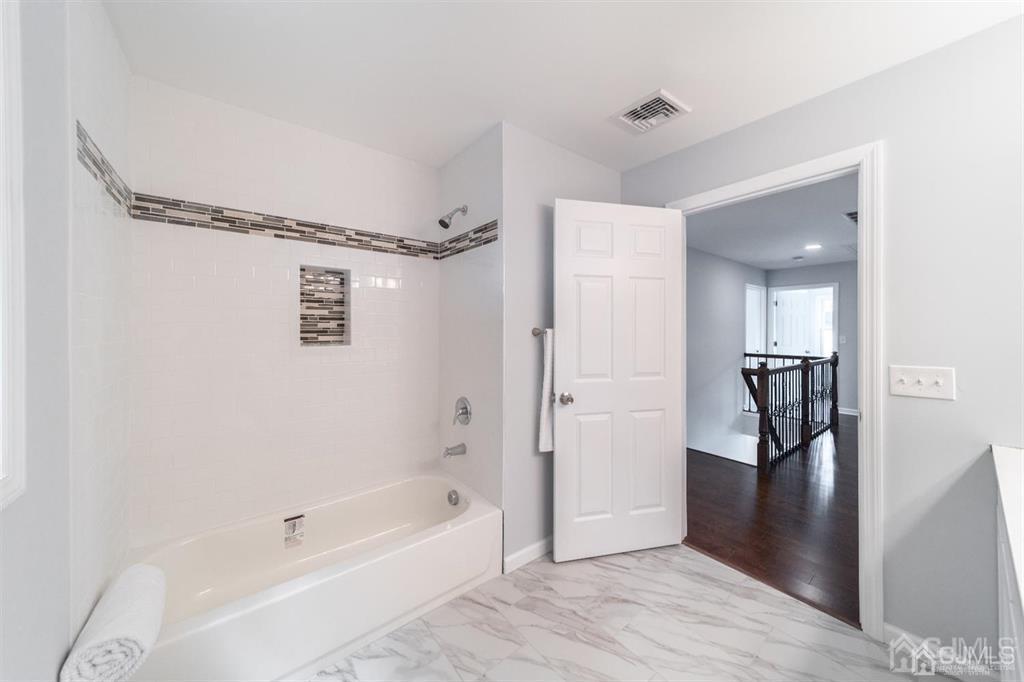 107 Winthrop Road Edison, NJ 08817 - Photo 33 of 38 a bathroom with a bathtub and a shower