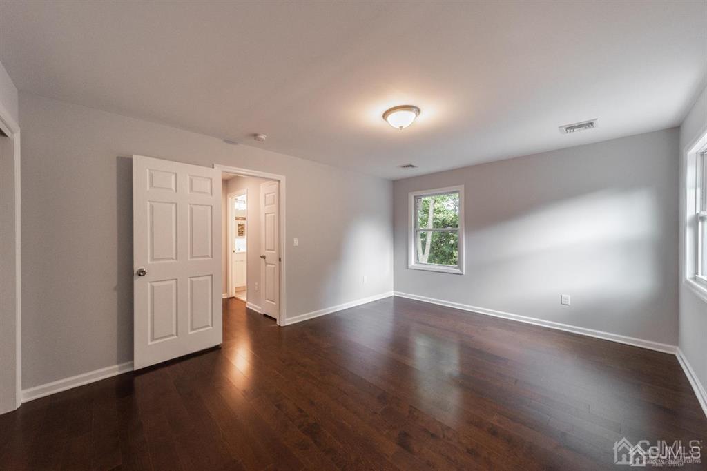 107 Winthrop Road Edison, NJ 08817 - Photo 34 of 38 an empty room with wooden floor and windows