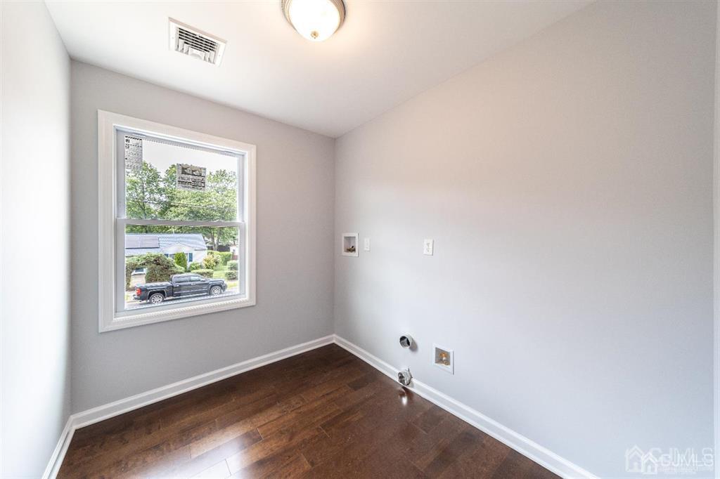 107 Winthrop Road Edison, NJ 08817 - Photo 35 of 38 an empty room with wooden floor and windows