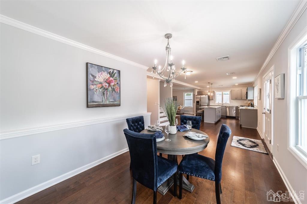 107 Winthrop Road Edison, NJ 08817 - Photo 5 of 38 a view of a dining room with furniture a chandelier and wooden floor