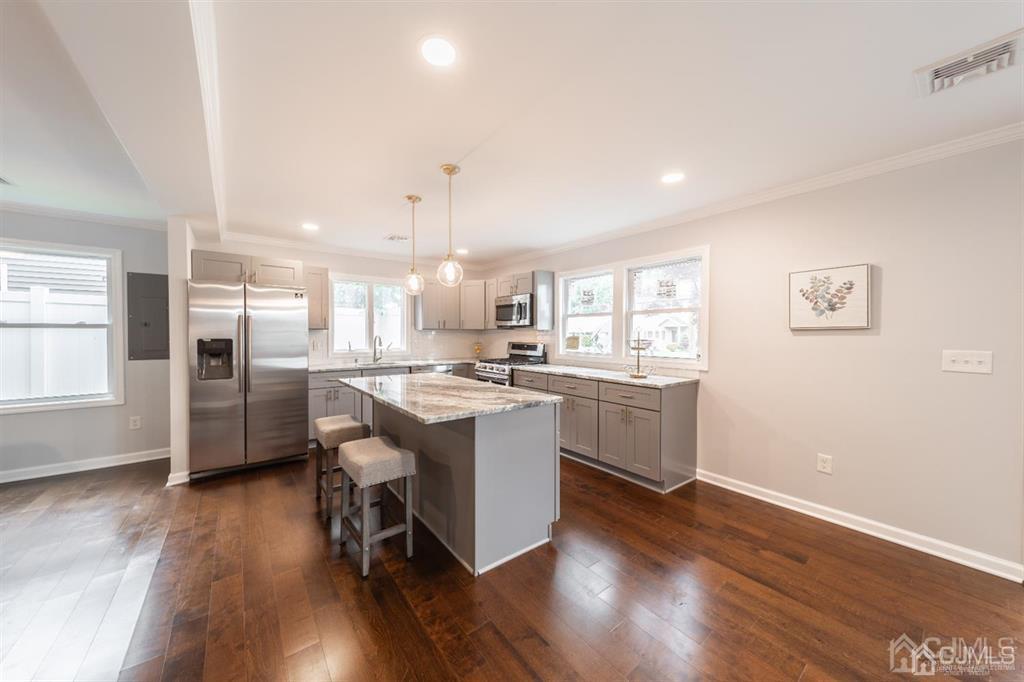 107 Winthrop Road Edison, NJ 08817 - Photo 6 of 38 a kitchen with a sink cabinets stainless steel appliances and wooden floor