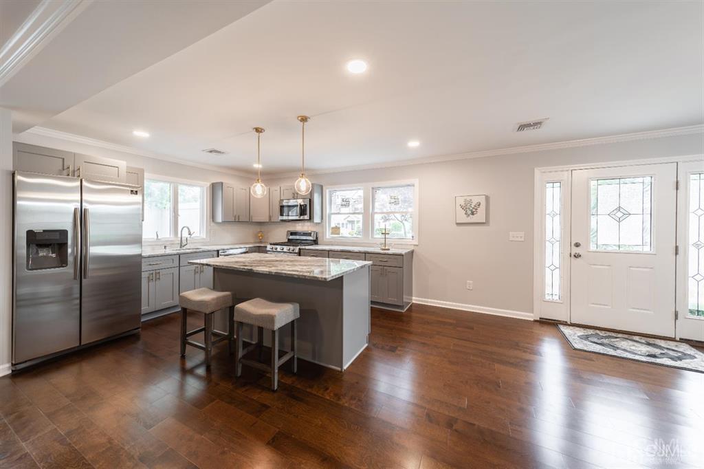 107 Winthrop Road Edison, NJ 08817 - Photo 8 of 38 a kitchen with a refrigerator and wooden floor